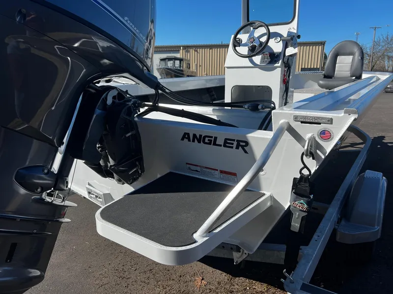 Slide: The Image of 2024 Fish Rite Angler 18 boat, rear view with motor and steering console. - 14