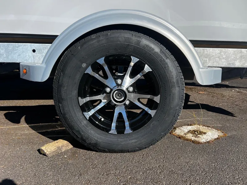 Slide: The Image of 2024 Fish Rite Angler 18 trailer wheel with black and silver alloy rim. - 16