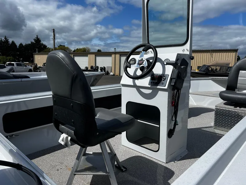 Slide: The Image of 2024 Fish Rite Angler 18 boat interior with steering console and seating. - 17