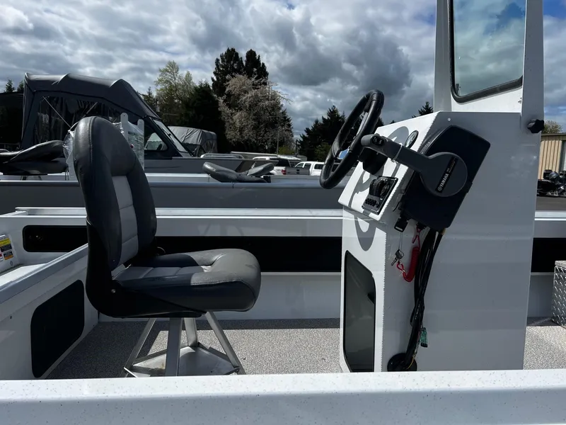 Slide: The Image of 2024 Fish Rite Angler 18 boat interior with steering console and captain's chair. - 18