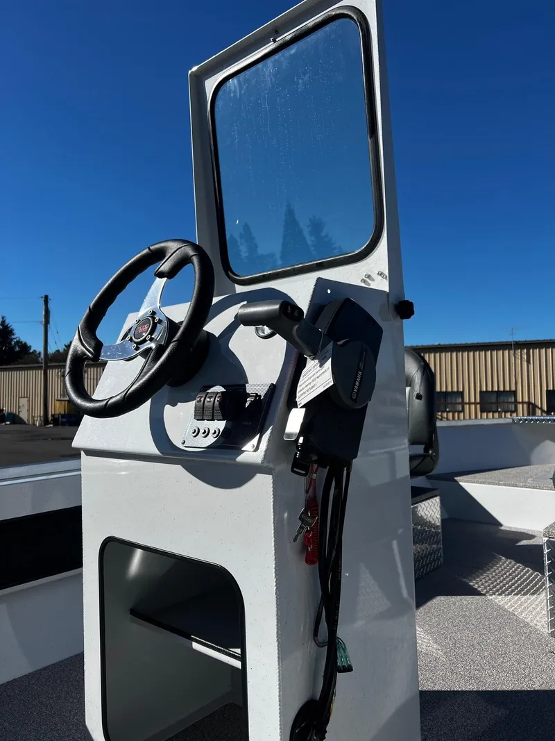 Slide: The Image of 2024 Fish Rite Angler 18 boat console with steering wheel and controls. - 7