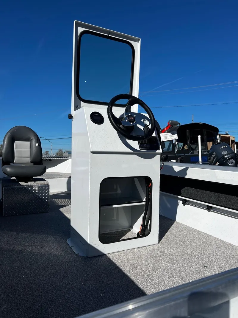 Slide: The Image of 2024 Fish Rite Angler 18 boat console with steering wheel and seat. - 8