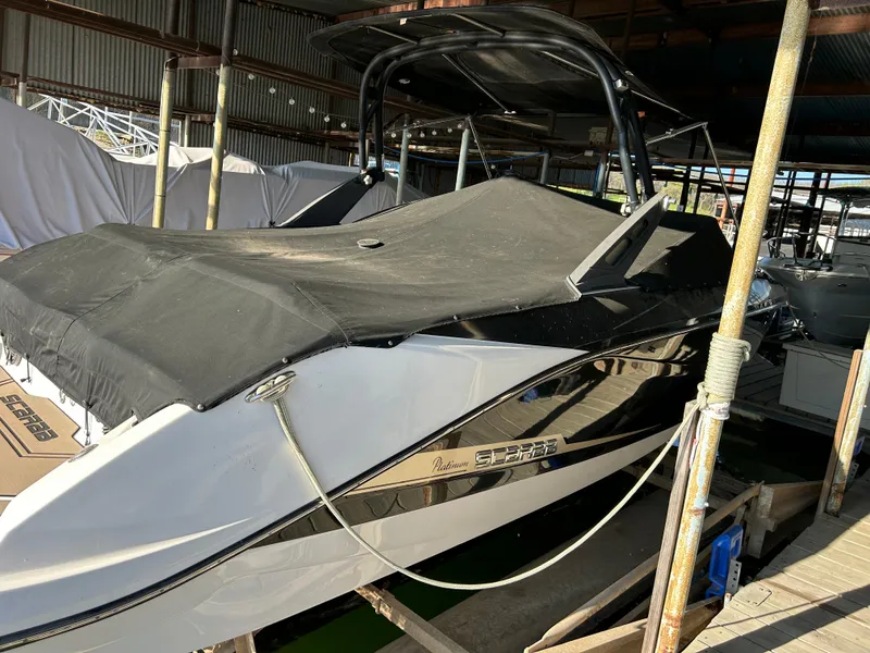 Slide: The Image of 2017 Scarab 255 boat with black cover, docked in a sheltered marina. - 4