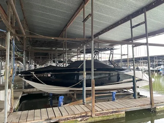 Slide: The Image of 2017 Scarab 255 boat docked in a marina under a covered structure. - 6