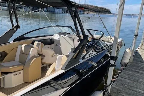 Slide: The Image of 2017 Scarab 255 boat docked on calm water, featuring sleek design and comfortable seating. - 8