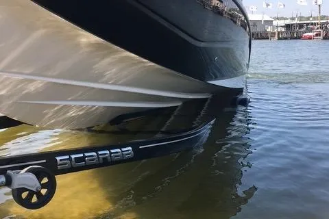 Slide: The Image of 2017 Scarab 255 boat partially submerged in water, showcasing sleek design and branding. - 9