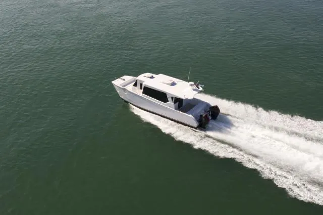 Slide: The Image of Aerial view of 2025 SilverCAT 34LUX boat cruising on open water. - 4