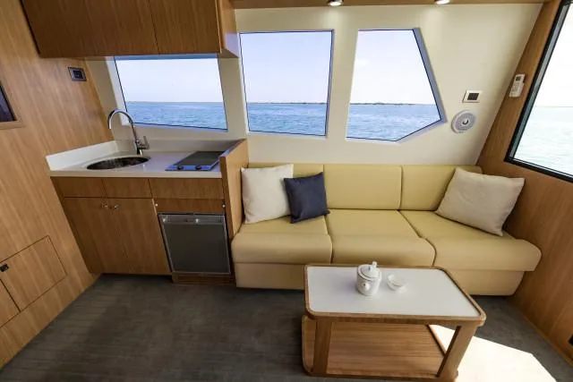 Slide: The Image of Luxurious SilverCAT 34LUX 2025 yacht interior with kitchenette, sofa, and ocean view. - 6