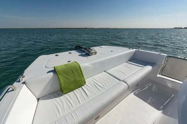 Slide: The Image of Luxurious SilverCAT 34LUX boat deck with green towel, 2025 model, on serene ocean waters. - 7