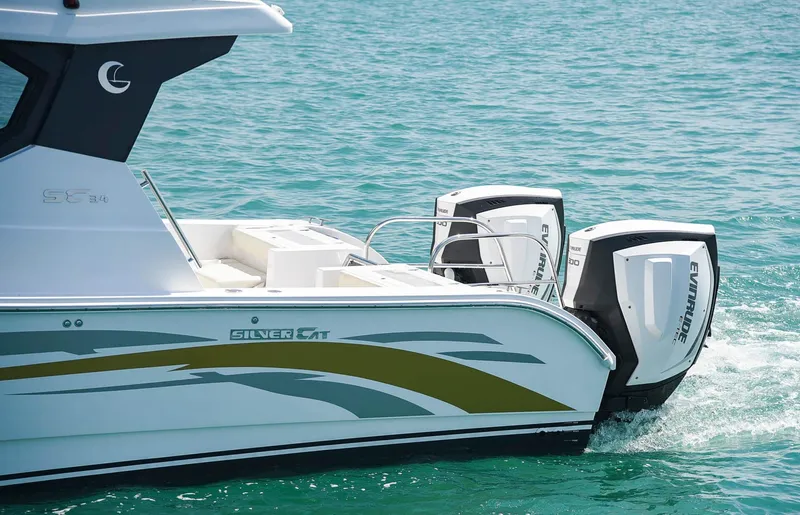 Slide: The Image of 2025 Custom SILVERCAT 34HT boat with dual engines on turquoise water. - 2