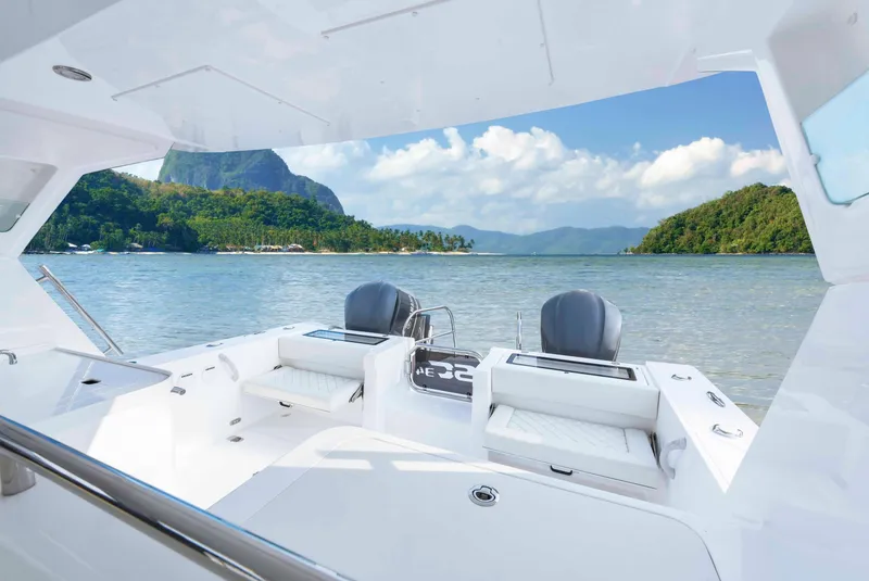 Slide: The Image of 2025 Custom SILVERCAT 34HT boat on scenic lake with lush green hills. - 4