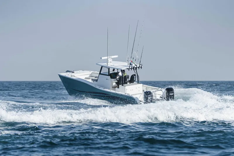 Slide: The Image of 2025 SilverCAT 34 CC boat cruising on open water with fishing rods. - 12