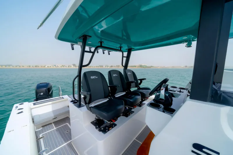 Slide: The Image of 2025 SilverCAT 34 CC boat interior with modern seating and controls on open water. - 4