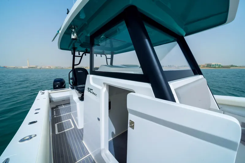 Slide: The Image of 2025 SilverCAT 34 CC boat on water, showcasing sleek design and spacious deck. - 7