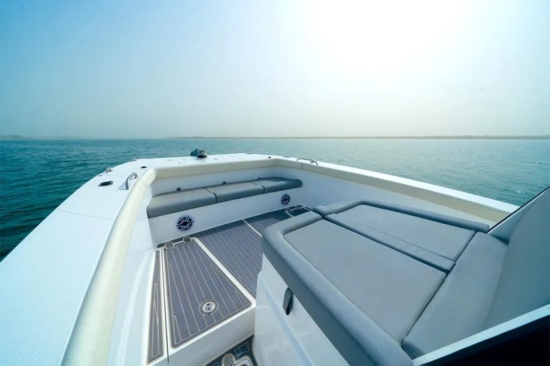 Slide: The Image of 2025 SilverCAT 34 CC boat with spacious deck and seating, cruising on calm waters. - 8