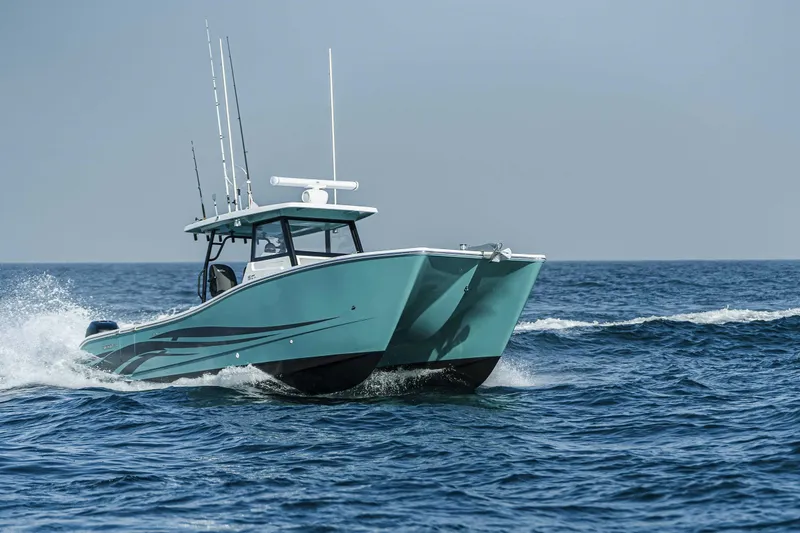 Slide: The Image of 2025 SilverCAT 34 CC catamaran cruising on open sea, showcasing sleek design and performance. - 9