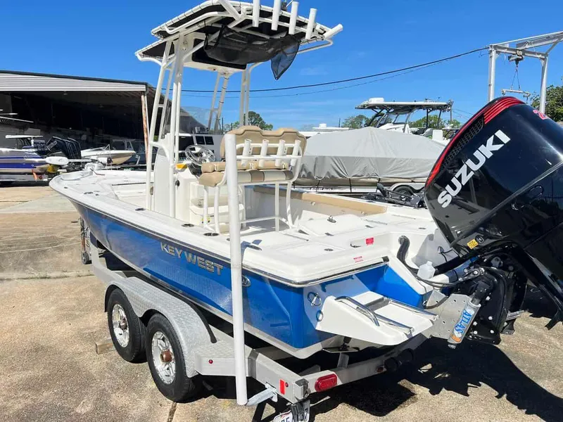 Slide: The Image of 2019 Key West 230 Bay Reef boat with Suzuki outboard motor on trailer. - 11