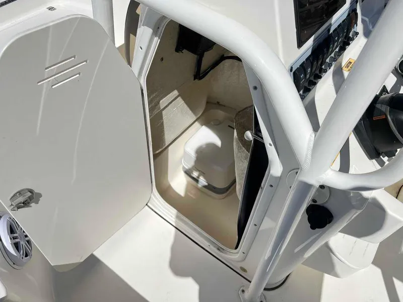 Slide: The Image of 2019 Key West 230 Bay Reef boat interior with open storage compartment. - 6