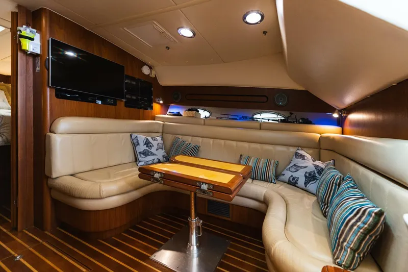Slide: The Image of Luxurious interior of 2004 Tiara Yachts 38 Express with leather seating and wooden table. - 11