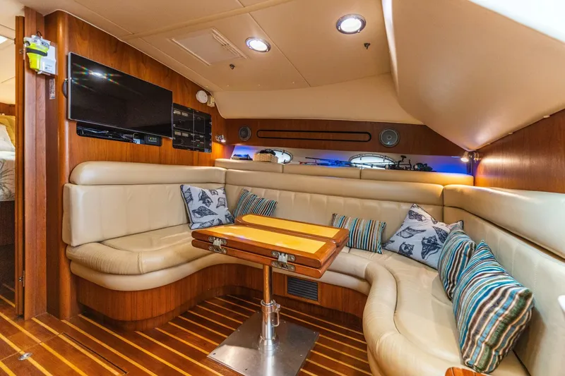 Slide: The Image of Luxurious interior of 2004 Tiara Yachts 38 Express with leather seating and wooden table. - 12