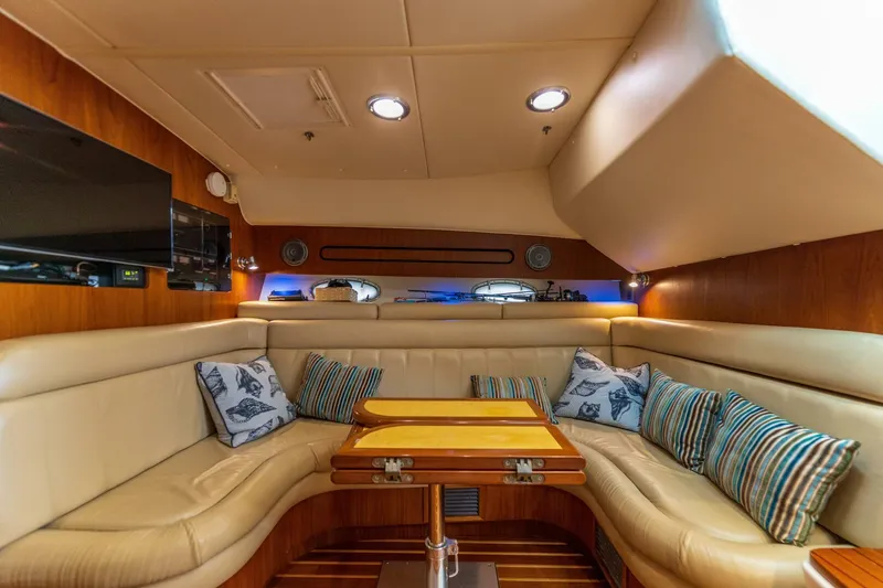 Slide: The Image of Luxurious interior of 2004 Tiara Yachts 38 Express with plush seating and wooden table. - 15