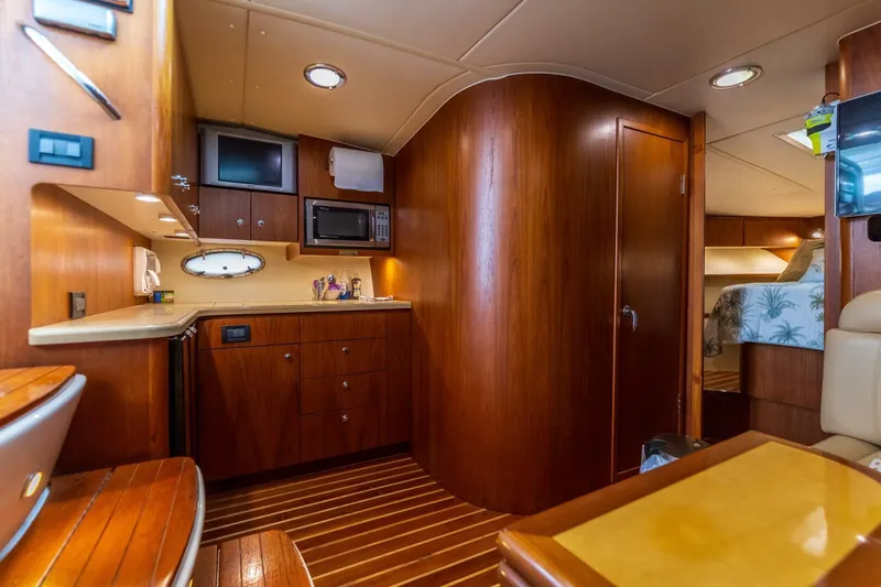 Slide: The Image of 2004 Tiara Yachts 38 Express interior with wood cabinetry and modern amenities. - 19