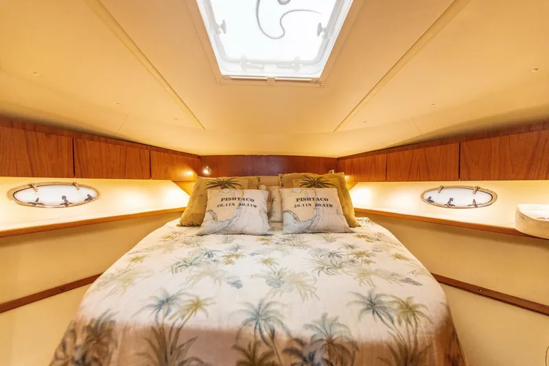 Slide: The Image of Luxurious bedroom in 2004 Tiara Yachts 38 Express with skylight and tropical bedding. - 20