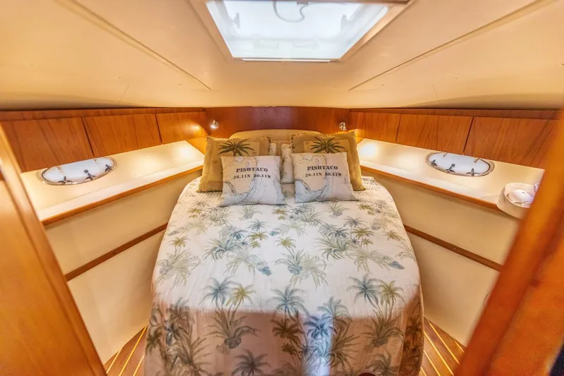 Slide: The Image of 2004 Tiara Yachts 38 Express cabin with cozy bed and tropical decor. - 21
