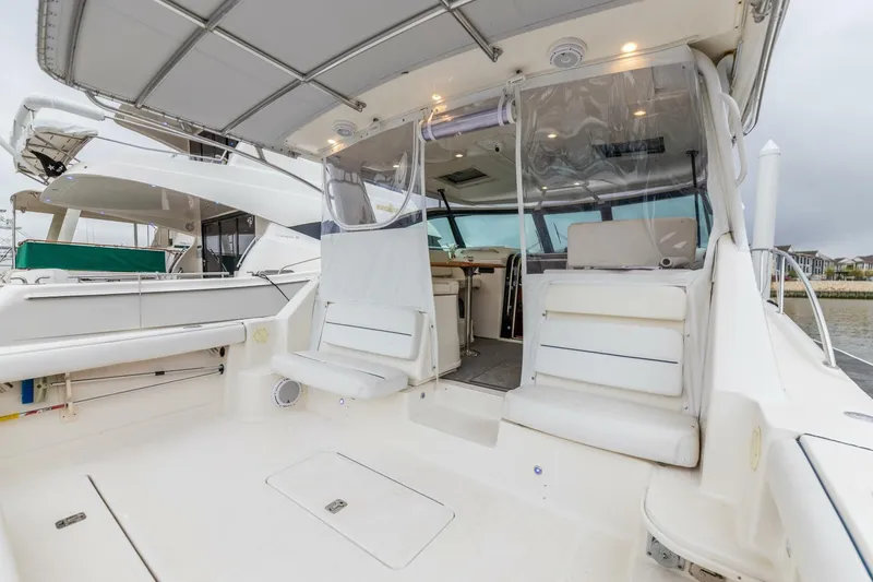 Slide: The Image of 2004 Tiara Yachts 38 Express boat interior with seating and covered cockpit. - 23