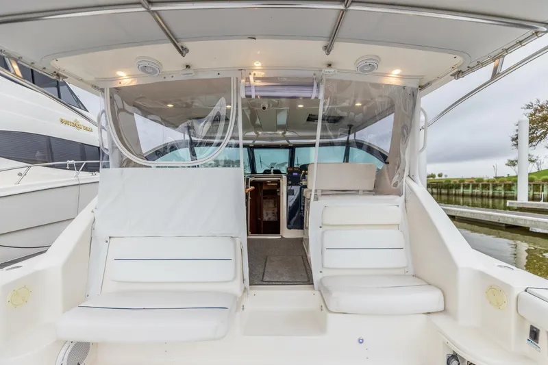 Slide: The Image of 2004 Tiara Yachts 38 Express boat interior with seating and helm station. - 24