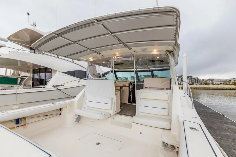 Slide: The Image of 2004 Tiara Yachts 38 Express boat with spacious deck and covered seating area. - 27