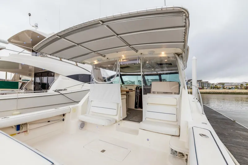 Slide: The Image of 2004 Tiara Yachts 38 Express boat with spacious deck and covered seating area. - 28