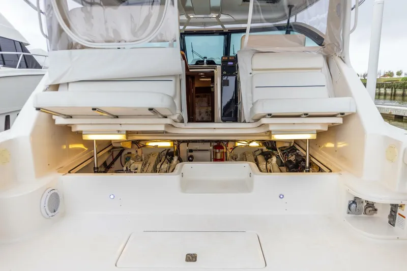 Slide: The Image of 2004 Tiara Yachts 38 Express with open engine compartment and seating area. - 30