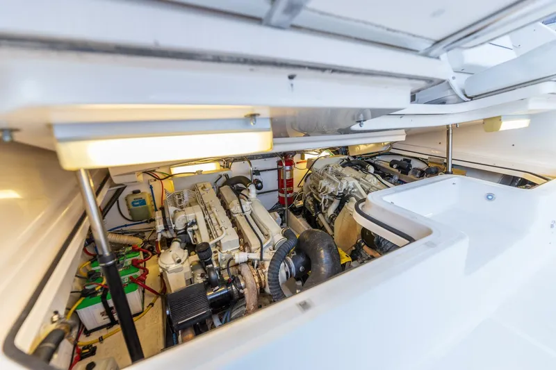 Slide: The Image of Engine room of a 2004 Tiara Yachts 38 Express, showcasing twin engines and clean layout. - 32
