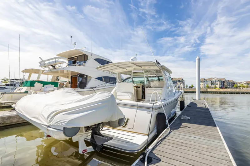 Slide: The Image of 2004 Tiara Yachts 38 Express docked at a marina on a sunny day. - 37