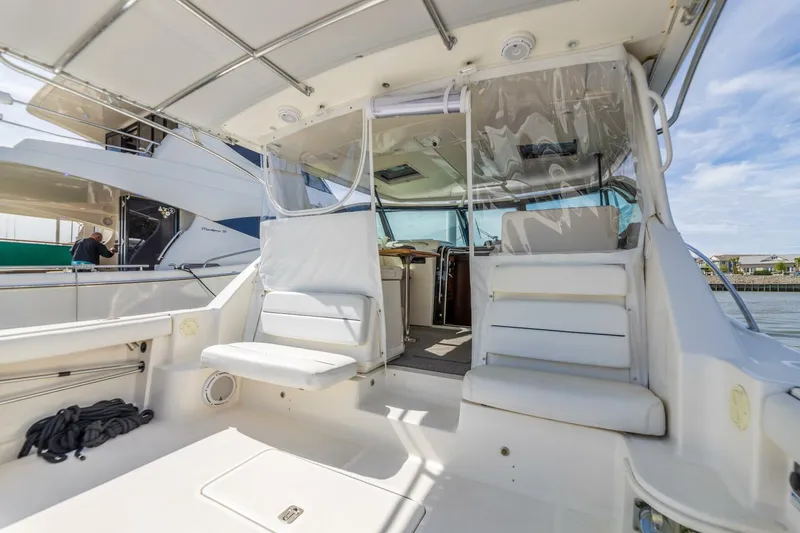 Slide: The Image of 2004 Tiara Yachts 38 Express boat interior with white seating and covered cockpit. - 38
