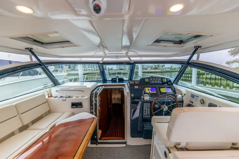 Slide: The Image of 2004 Tiara Yachts 38 Express cockpit with helm, seating, and navigation equipment. - 4