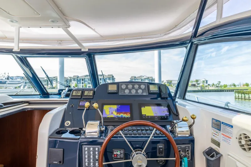 Slide: The Image of Helm of 2004 Tiara Yachts 38 Express with navigation equipment and waterfront view. - 42