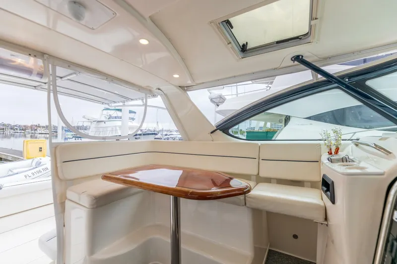 Slide: The Image of Interior of 2004 Tiara Yachts 38 Express with seating and wooden table. - 5