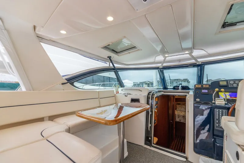 Slide: The Image of Interior of 2004 Tiara Yachts 38 Express, featuring helm and seating area. - 9