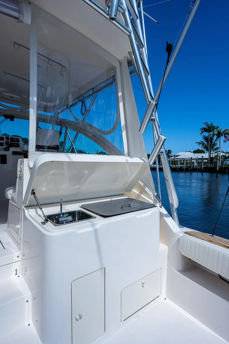 Slide: The Image of 2005 Albemarle 410 boat with outdoor sink and storage, docked by a serene waterfront. - 31
