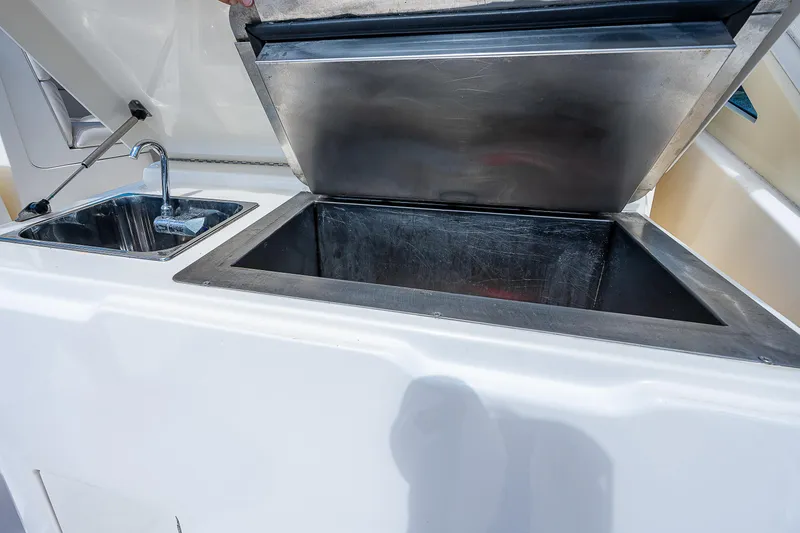 Slide: The Image of 2005 Albemarle 410 boat with open storage compartment and sink. - 35