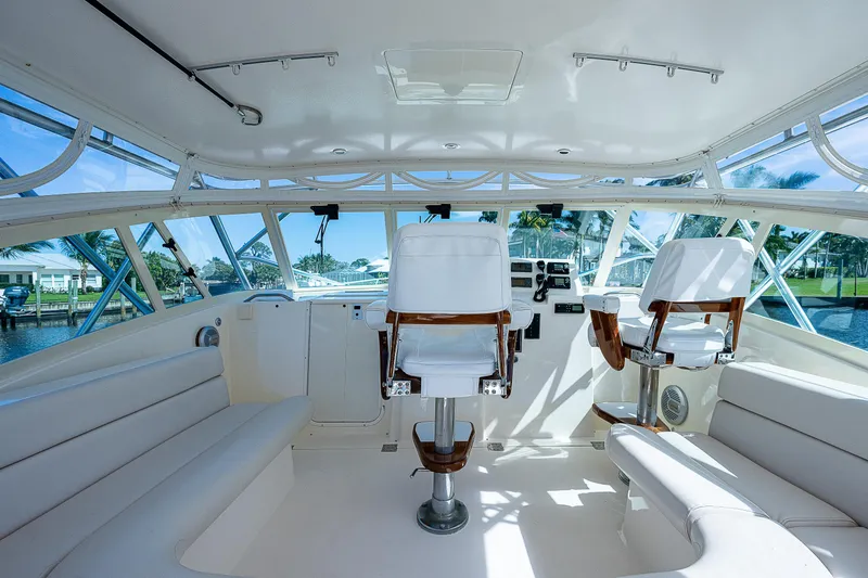 Slide: The Image of Interior of a 2005 Albemarle 410 boat with white seating and helm chairs. - 38