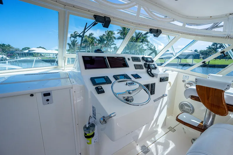 Slide: The Image of Helm of 2005 Albemarle 410 boat with modern navigation equipment and scenic marina view. - 41