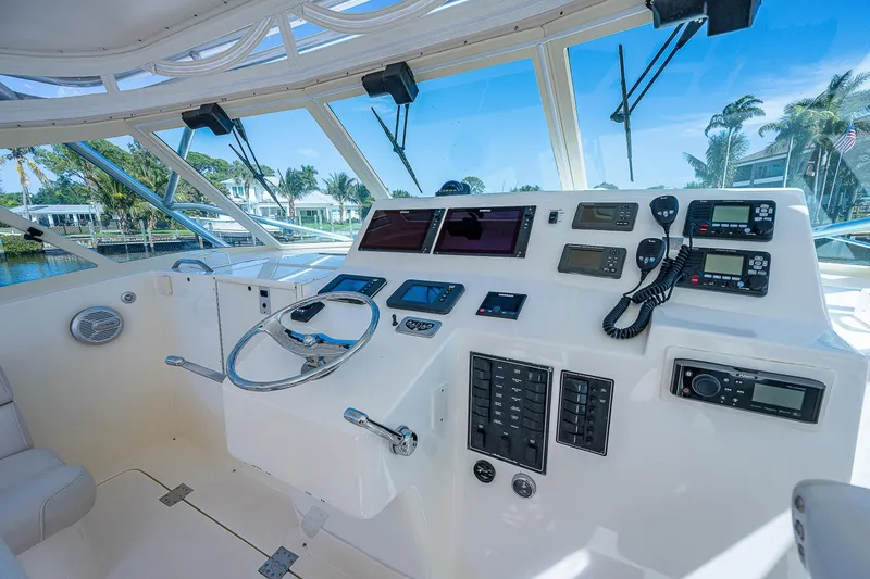 Slide: The Image of 2005 Albemarle 410 boat helm with advanced navigation and communication equipment. - 43