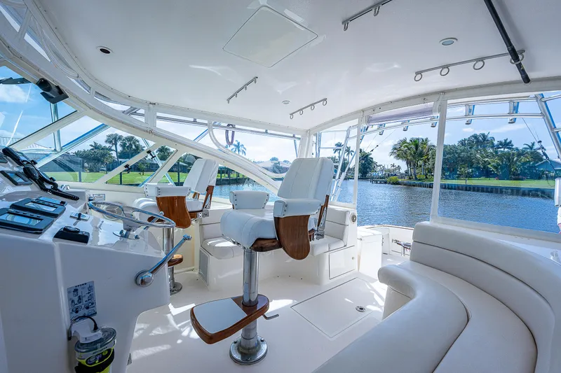 Slide: The Image of Interior of 2005 Albemarle 410 yacht with helm chairs and waterfront view. - 44