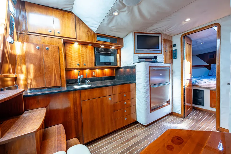 Slide: The Image of Interior of a 2005 Albemarle 410 yacht with wooden cabinetry and modern amenities. - 47