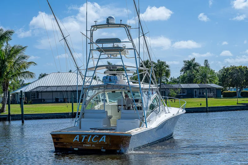 Slide: The Image of 2005 Albemarle 410 boat named ATICA on a sunny day in a marina. - 8