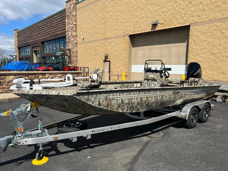The Image of 2024 Ranger RB210 boat on a trailer outside a building. - 0
