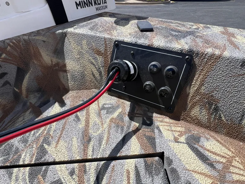 Slide: The Image of Control panel of 2024 Ranger RB210 boat with camo design and Minn Kota trolling motor. - 6